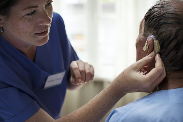 Elderly man wearing hearing aid